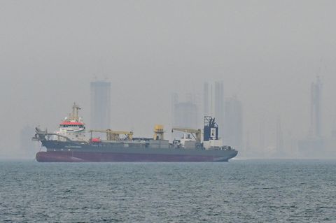 Ein Schiff liegt wegen des Kriegs im Iran vor Dubai vor Anker