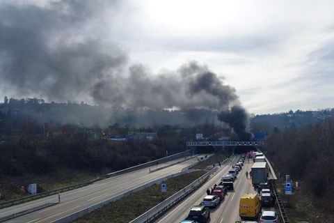 Schwarzer Rauch steigt aus der Tunneleinfahrt, während sich auf der A81 Autos stauen