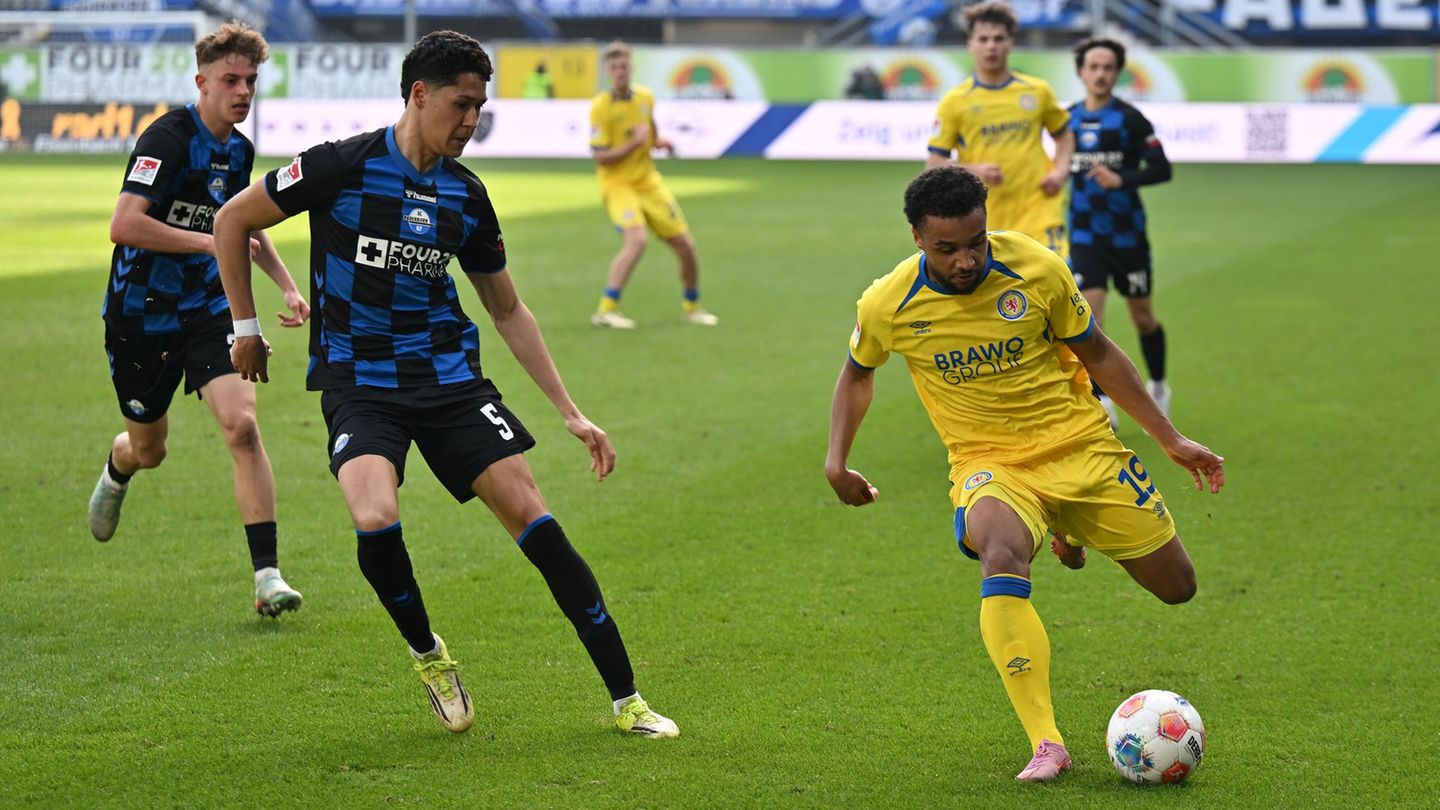 Umkämpftes Duell: Paderborns Santiago Castaneda und Braunschweigs Leon Bell Bell. Foto: Swen Pförtner/dpa