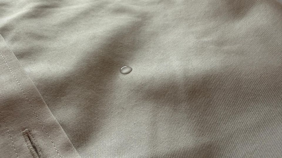 Ein Tropfen perlt auf der Hemd-Oberfläche