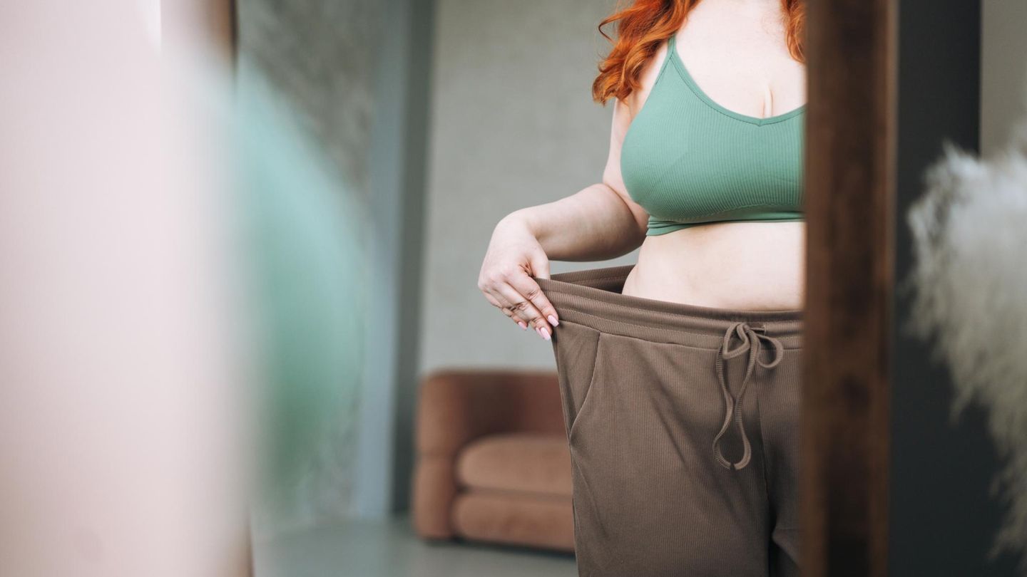 Frau trägt Übergroße Hose, zeigt Gewichtsverlust