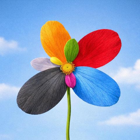 Auf dem Bild sieht man eine Blume in Farben verschiedener Parteien vor blauem Frühlingshimmel. (Symbolbild Umfragen)