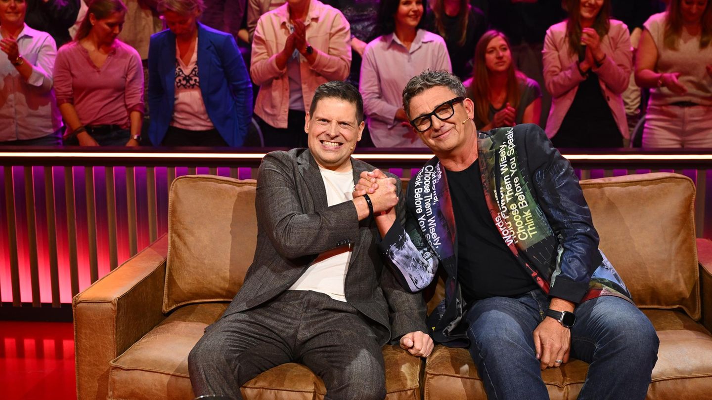 Hans Sigl und Jan Ullrich sitzen auf einem Sofa