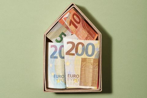Ein Symbolhaus mit Geldscheinen drin - Beziehung, Haushalt und Finanzen