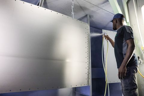 Ein Arbeiter aus Gambia bereitet in einem Unternehmen im Erzgebirge Stahlbleche für die Oberflächenbehandlung vor. (Archivbild)