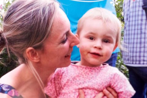 Mutter hält die Tochter im Arm