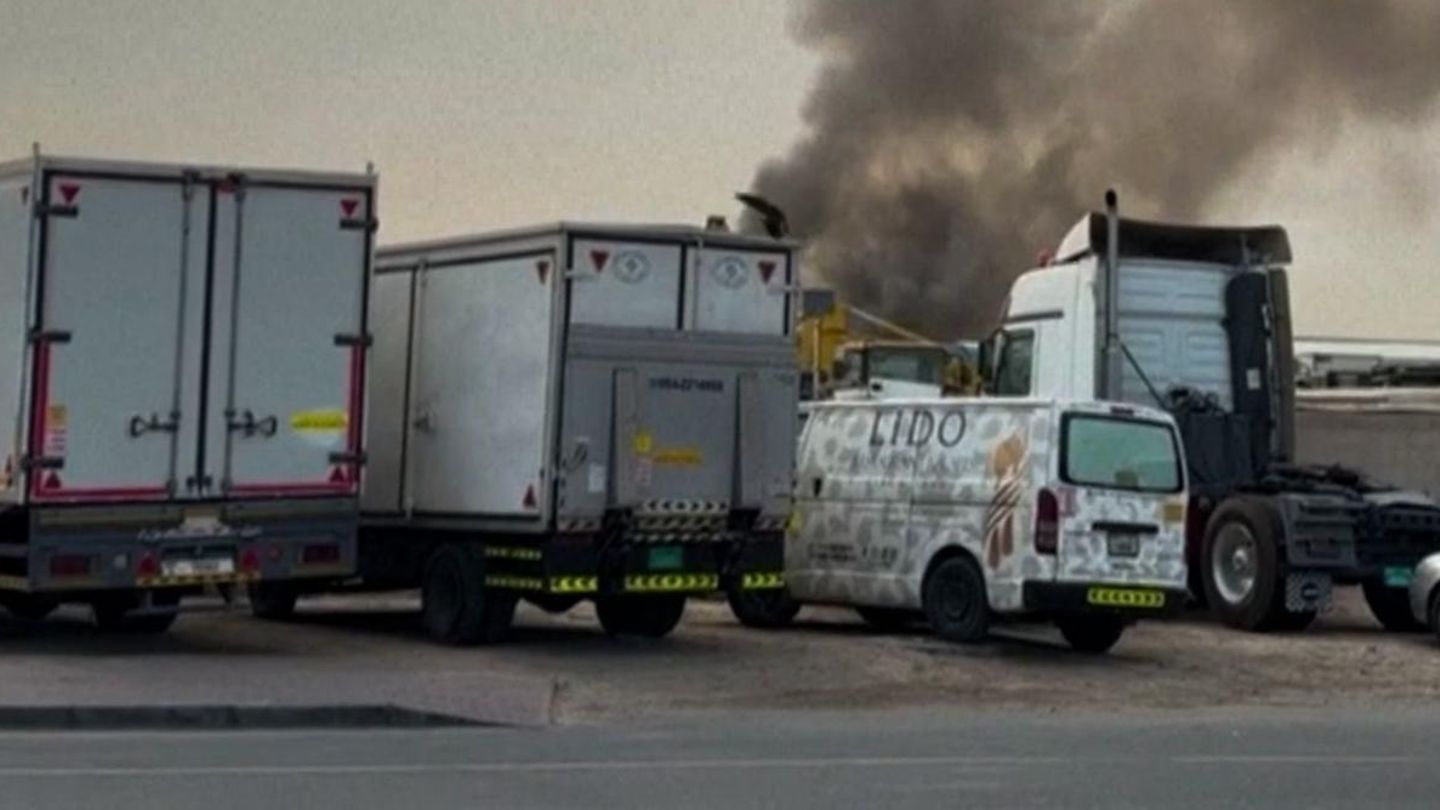 Rauchwolke am Himmel über abgestellten LKW
