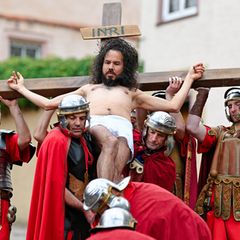 Laiendarsteller spielen den Kreuzweg Jesu Christi nach. Foto: Uwe Anspach/dpa