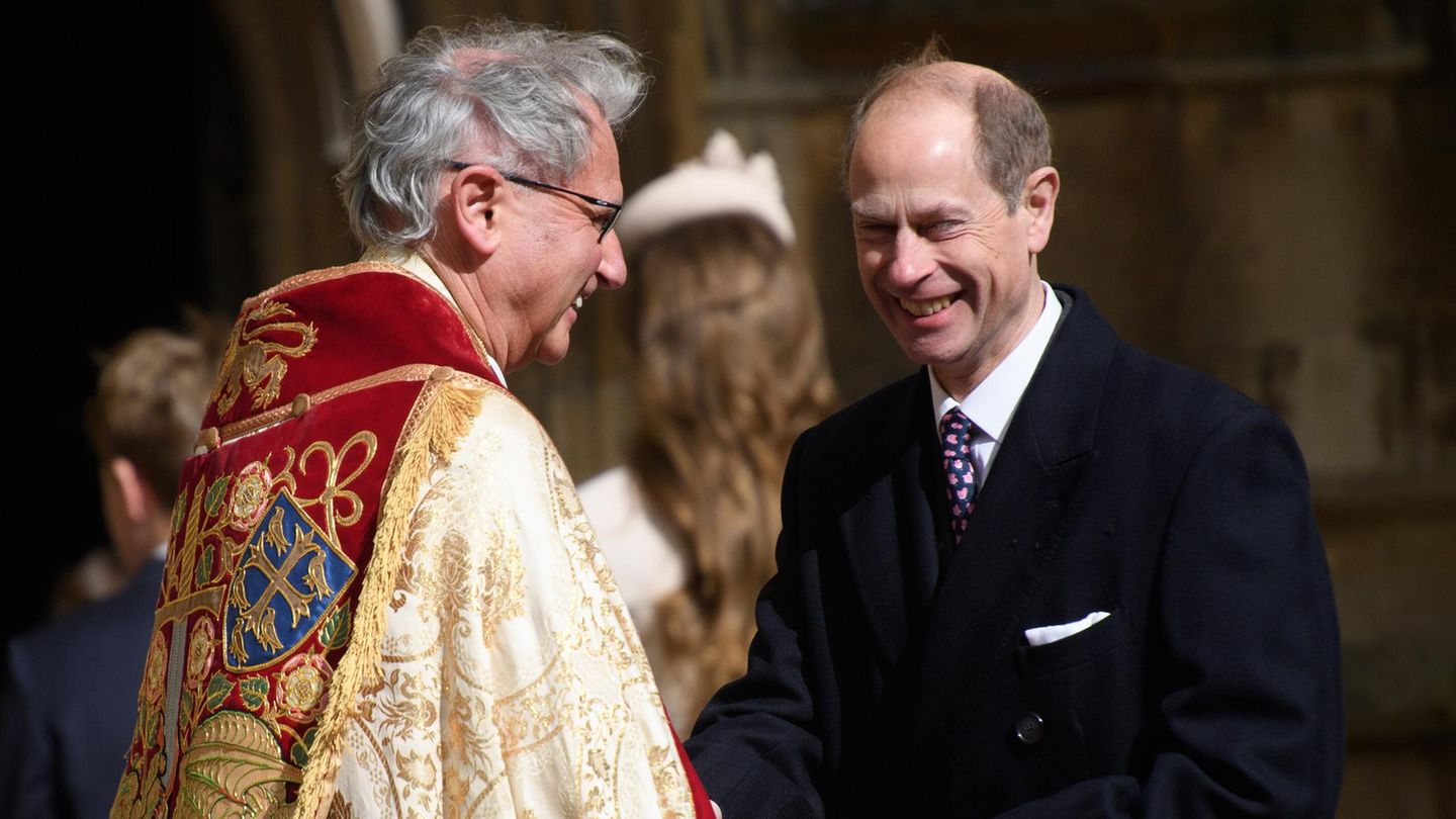 Prinz Edward lächelt im Gespräch mit einem Priester