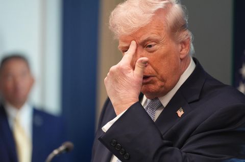 Donald Trump zeigt sich an die Stirn während der Pressekonferenz