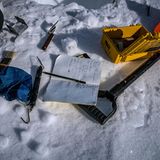 Auf dem Schnee der Antarktis liegen Schaufeln und Stecheisen