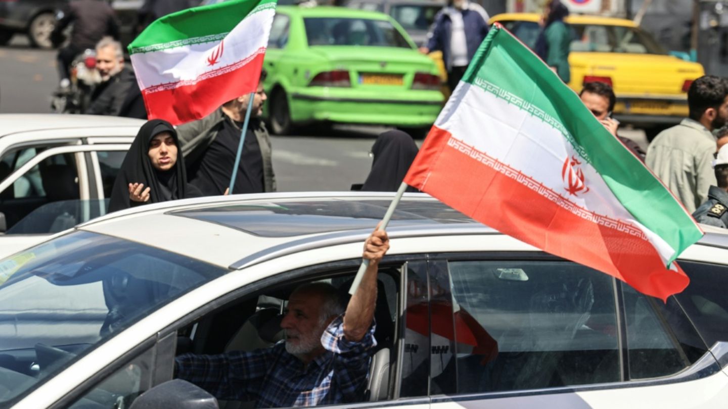 Mann mit iranischer Flagge in Teheran