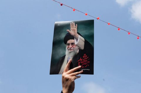 Bei der Trauerfeier in Teheran hält eine Frau ein Bild des von den USA getöteten Ajatollah Ali Chamenei hoch