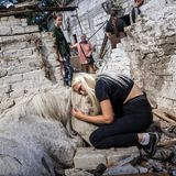 Frau umarmt getötetes Pferd