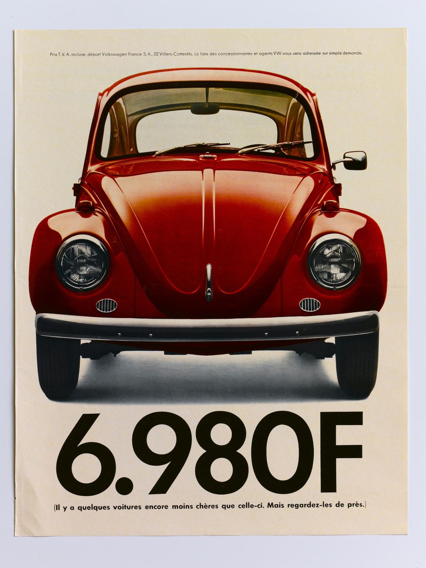 Ein Plakat für VW mit einem roten VW Käfer abgebildet