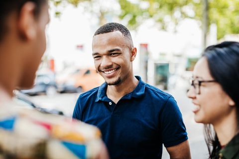 Portrait of a man wearing red polo shirt with skyscrapers of Miami Downtown in background