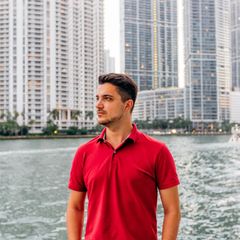 Portrait of a man wearing red polo shirt with skyscrapers of Miami Downtown in background