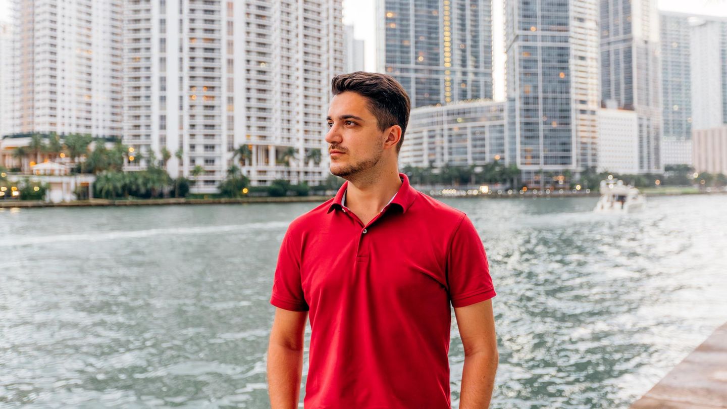 Portrait of a man wearing red polo shirt with skyscrapers of Miami Downtown in background
