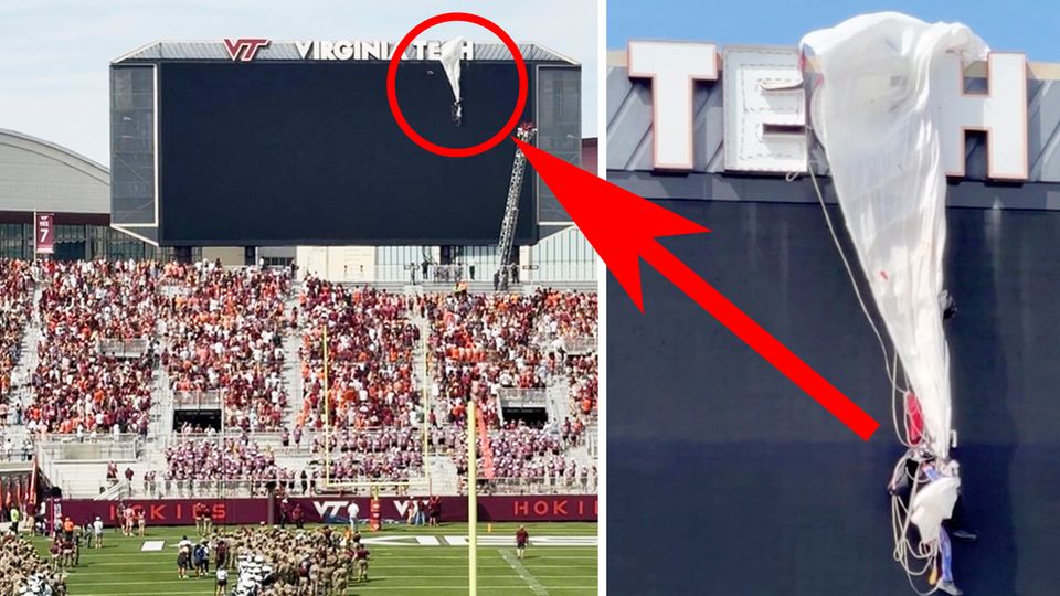 Fallschirmspringer kracht in Anzeigetafel eines Stadions