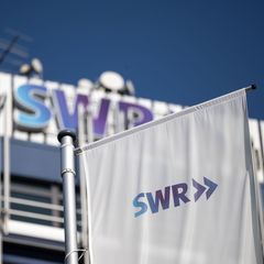 Das Logo des Südwestrundfunks (SWR) ist an einer Flagge des Funkhauses in der Innenstadt zu sehen