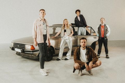 Die fünf Mitglieder der Band „Das Lumpenpack“ vor einem Auto
