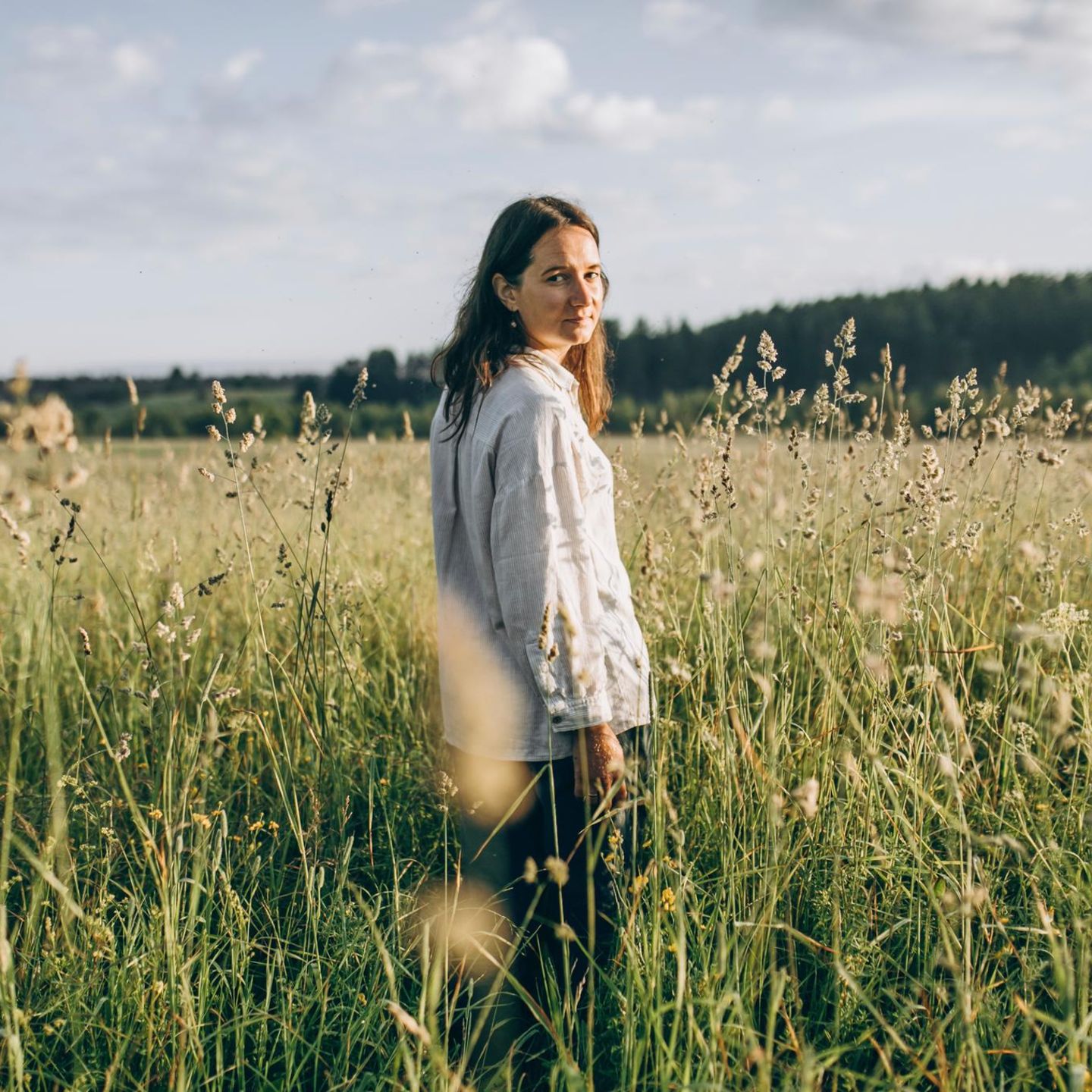 Eine Frau steht in einem Feld in der Natur