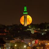 Istanbul, Türkei. Der Vollmond, auch bekannt als Blumenmond, geht am Morgen hinter dem Beyazit-Turm unter.