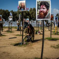 Trauernde mit Bilder der Opfer des Hamas-Angriffs