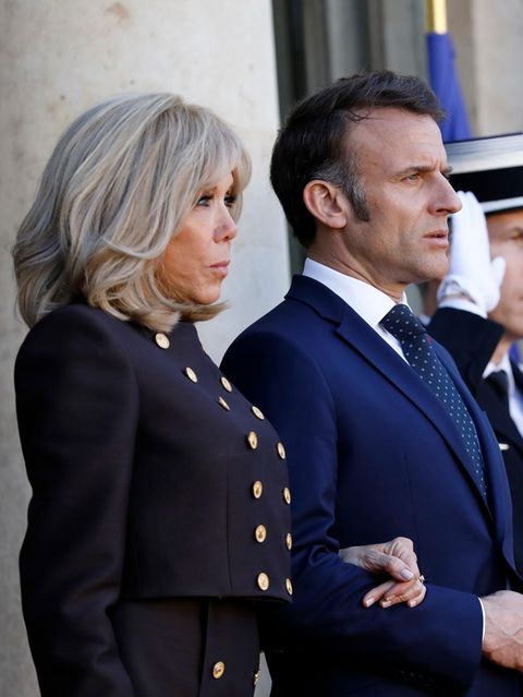 Brigitte Macron steht neben ihrem Mann