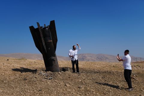 Menschen neben dem Wrack einer iranischen Rakete, die im Westjordanland eingeschlagen ist. Foto: Mahmoud Illean/AP/dpa