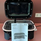 Der Lieferumfang des Weber Lumin umfasst natürlich den Grill inklusive Elektroteil, den gusseisernen Rost und die Bedienungsanleitung