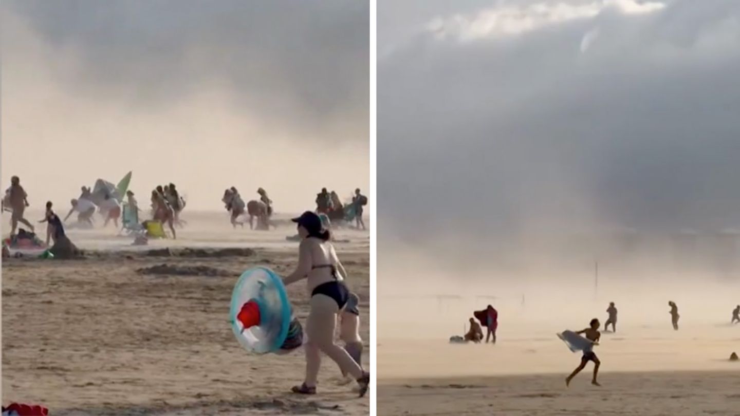 Violent storm sweeps across beach - | Tourists flee from 