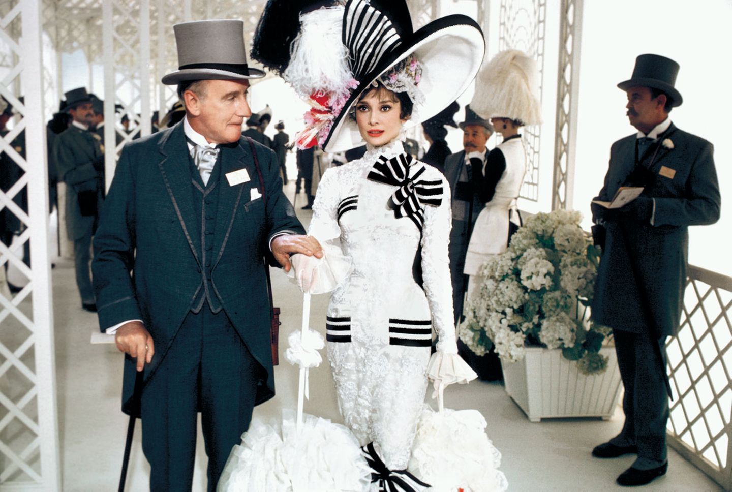 In dieser Szene wird die von Hepburn verkörperte Eliza Doolittle von Colonel Pickering (Wilfrid Hyde-White) zum Pferderennen in Ascot begleitet.  www.taschen.com
