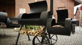 Immer mehr ambitionierte Griller in Deutschland wagen sich an die nächste Stufe der Fleischzubereitung im Freien: dem Garen bei niedrigen Temperaturen um die 90 bis 110 Grad. Das Gerät für diesen Job ist der Smoker. Er heißt so, weil er mit heißem Rauch das Fleisch langsam durchgart. Feuer und Grillgut sind strikt voneinander getrennt. An der Seite etwas unterhalb der Garkammer, ist die Hitzequelle angebracht, die Sidefirebox. Hier wird mit Holzscheiten ein Feuer entfacht. Hitze und Rauch ziehen in die Garkammer, über das Grillgut hinweg und dann über ein Ofenrohr nach oben wieder ab.