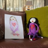 Edda hatte eine besondere Idee: Die Fünfzehnjährige hatte 2013 ihr Schülerpraktikum in unserer Redaktion gemacht und Ende des Jahres eine kleine Schwester bekommen, Lova. Edda malte für ihre Schwester ein Mädchen mit besonders langen Armen und "echten Chucks". Damit klar ist, wem das Bild gehört, hat sie mitten ins Herz "Lova" geschrieben. Ihre Puppe kann mit den langen Armen nun das Baby umschlingen.