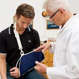 examination; 55; 60; appointment; appointments; arm; arms; case; cases; daylight; doctor; doctors; health; indoor; indoors; injuries; injury; inside; man; medical; men; people; sports injuries; sports injury; sprain; sprains; visit; visits; consultation