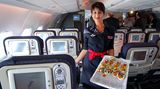 Fingerfood im Flug  Schnittchen bei Air France: Statt des herkömmlichen Tablettservice wird Fingerfood gereicht. Eine Neuigkeit des Unterhaltungssystems mit 600 Stunden Video-Auswahl und 3000 Musiktiteln ist die Kommunikation per Tastatur und Bildschirm. Die Passagiere können untereinander chatten. "Eine Art Facebook im Flugzeug", erklärt der Purser Hendrik Godat