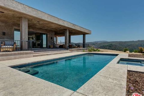 Der Außenbereich der Villa ist von klaren Linien, Beton und dem Pool bestimmt