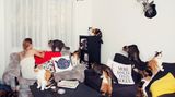Frau mit Katzen auf Sofa.