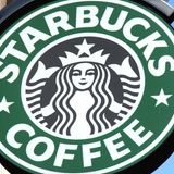 Das grüne Starbucks-Logo mit der schwarzen Nixe