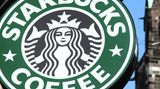 Das grüne Starbucks-Logo mit der schwarzen Nixe