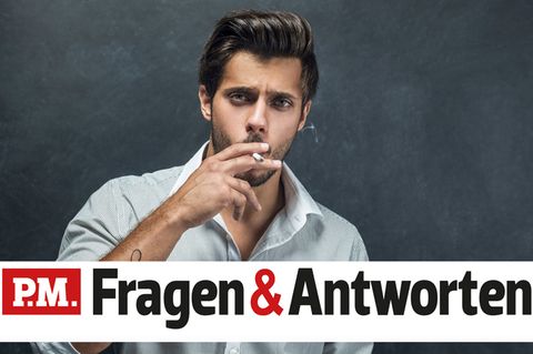 Ein schlanker Mann raucht eine Zigarette