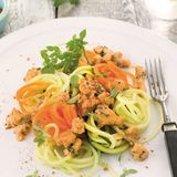 Gemüsespaghetti mit Hähnchen-Bolognese  Zutaten:  400 g Hähnchenbrust, 1 Zwiebel, 1 Knoblauchzehe, 2 EL Olivenöl, 2 EL Tomatenmark, 100 ml Gemüsebrühe, 50 g süße Sahne, Meersalz, frisch gemahlener schwarzer Pfeffer, 3 Stängel Oregano, 2 Karotten, 1 Kohlrabi, 2 dünne Zucchini, 1 Bund Petersilie, Saft von ½ Zitrone, Chilisalz (alternativ Cayennepfeffer und Salz), 2 Stängel Basilikum      Zubereitung:  1. Für die Bolognese die Hähnchenbrust grob würfeln und durch die grobe Scheibe des Fleischwolfs lassen. Zwiebel und Knoblauch abziehen und würfeln. 1 EL Olivenöl in einem Bräter erhitzen, das Fleisch darin kurz scharf anbraten. Die Zwiebel- und Knoblauchwürfel zugeben und anschwitzen. Das Tomatenmark unter Rühren anrösten. Mit Gemüsebrühe und Sahne aufgießen, Salz und Pfeffer zugeben. Den Oregano abbrausen, trocken schütteln und zugeben. Die Sauce bei mittlerer Temperatur offen 15 Minuten köcheln lassen.        2. Inzwischen das Gemüse waschen, die Karotten und den Kohlrabi schälen.  Mit Hilfe eines Spiralschneiders das Gemüse in lange dünne Spaghetti schneiden. Die Petersilie abbrausen, trocken schütteln und hacken.        3. Das restliche Olivenöl in einer Pfanne erhitzen, die Gemüsespaghet ti darin etwa 2 Minuten anschwitzen. Mit Salz und Pfeffer bestreuen. Oregano aus der Sauce nehmen und die Sauce mit Zitronensaft und Chilisalz abschmecken, die Petersilie unterrühren.        4. Die Gemüsespaghetti mit der Sauce anrichten. Basilikum waschen, trocken schütteln und die Blätter darüber streuen.