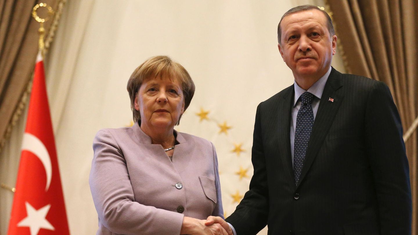 Handshake zwischen Angela Merkel und Recep Tayyip Erdogan - links die türkische Flagge