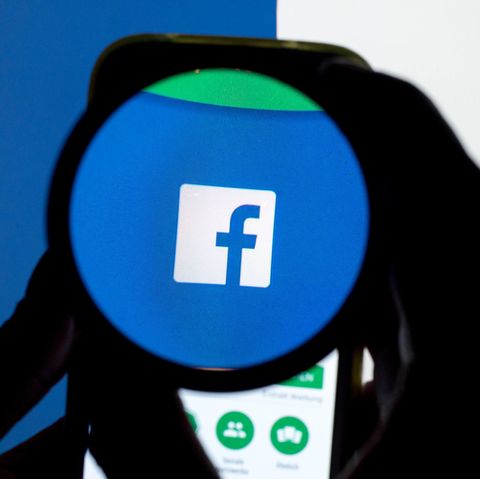 Das Facebook-Logo durch eine Lupe betrachtet