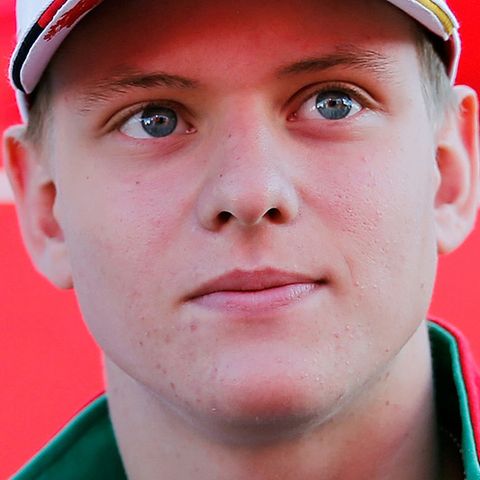 Im Rennanzug und mit Cap auf dem Kopf schaut Mick Schumacher, Sohn von Michael Schumacher, nach links oben
