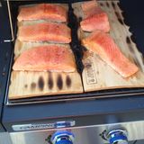 Fisch vom Grill ist sehr lecker, eine gute Alternative zum Fleisch aber etwas schwieriger im Umgang. Gegart auf einem Zedernholzbrettchen gelingt Fisch wie Lachs oder Seehecht fast immer. Am besten die Bretter über Nacht in Wasser einlegen und dann samt Fisch auf den Grill. Der vom heißen Holz aufsteigende Rauch verleiht dem Fisch eine leichte Räuchernote und so serviert macht das Meerestier auf dem Tisch auch optisch etwas her. Zedernholzbretter bieten viele Grillhersteller auf ihren Zubehörseiten an oder einfach im Baumarkt in die Grillabteilung schauen. 