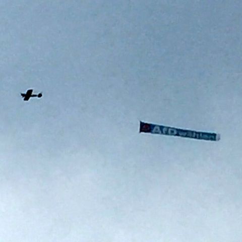Ein Flugzeug zieht ein Banner mit "AfD wählen" über den Himmel von Schleswig-Holstein