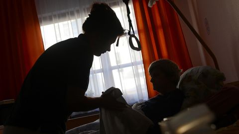 Eine Frau wird in einem Seniorenheim von einer Pflegerin betreut (Symbolbild)