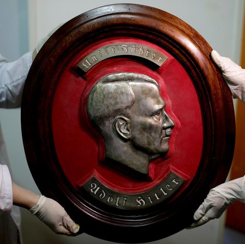Mitglieder der Bundespolizei zeigen im Interpol-Hauptquartier in Buenos Aires ein gefundenes Relief von Adolf Hitler